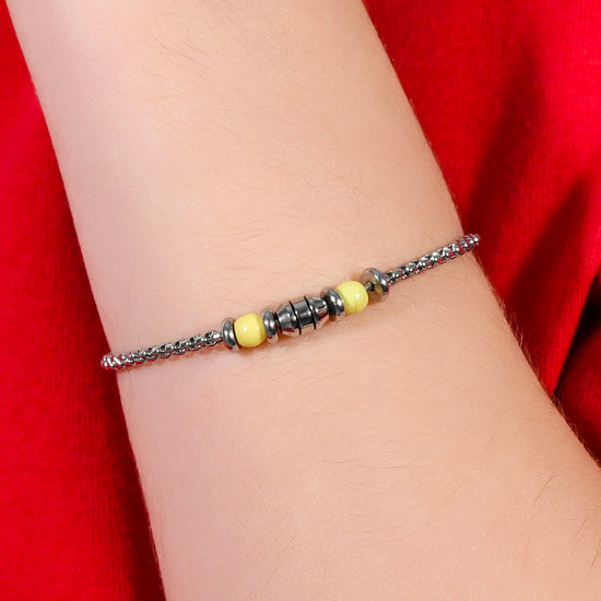 BRACELET BÉBÉ EN ACIER PIERRES JAUNES